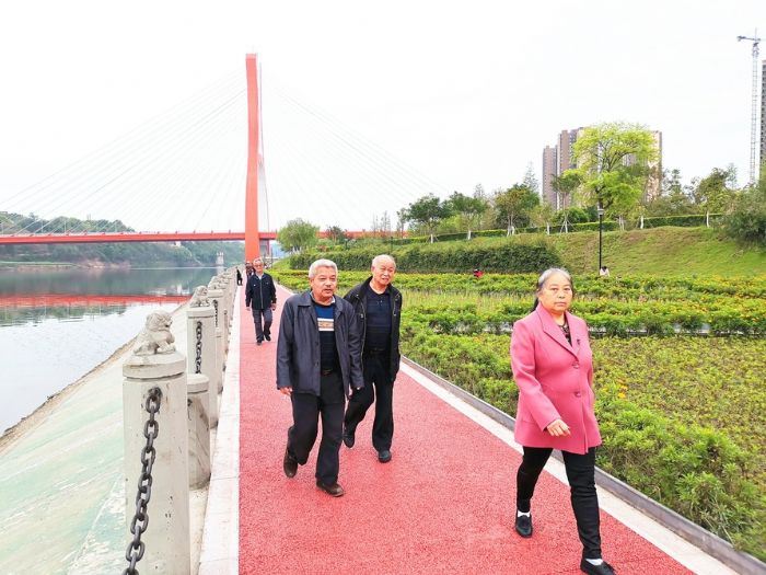 市民在滨江湿地公园彩色步道散步。
