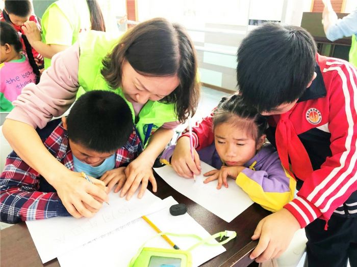 志愿者和学生们一起画画
