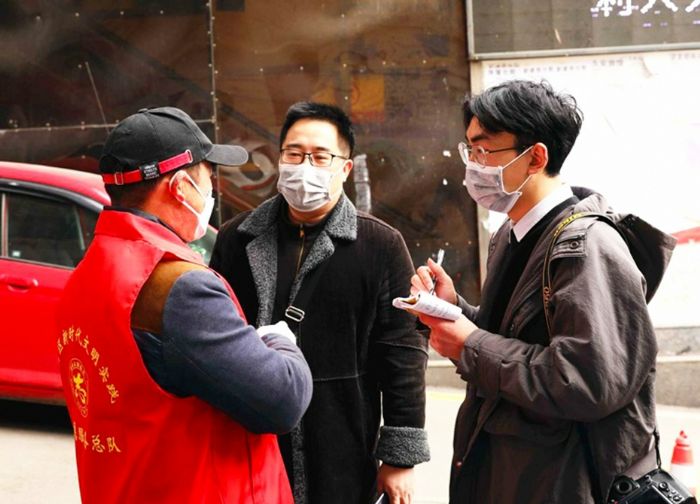 记者深入“疫”线采访志愿者。
