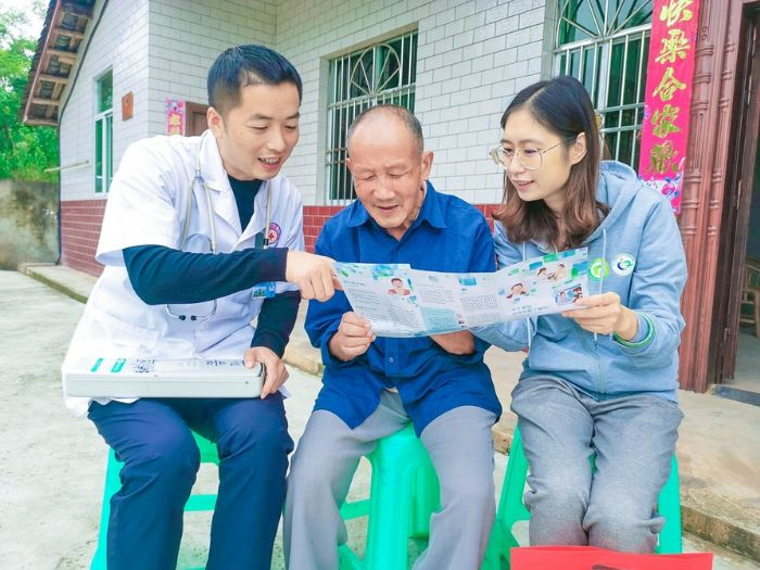 花岩镇卫生院医务人员上门为群众宣传健康扶贫政策。
